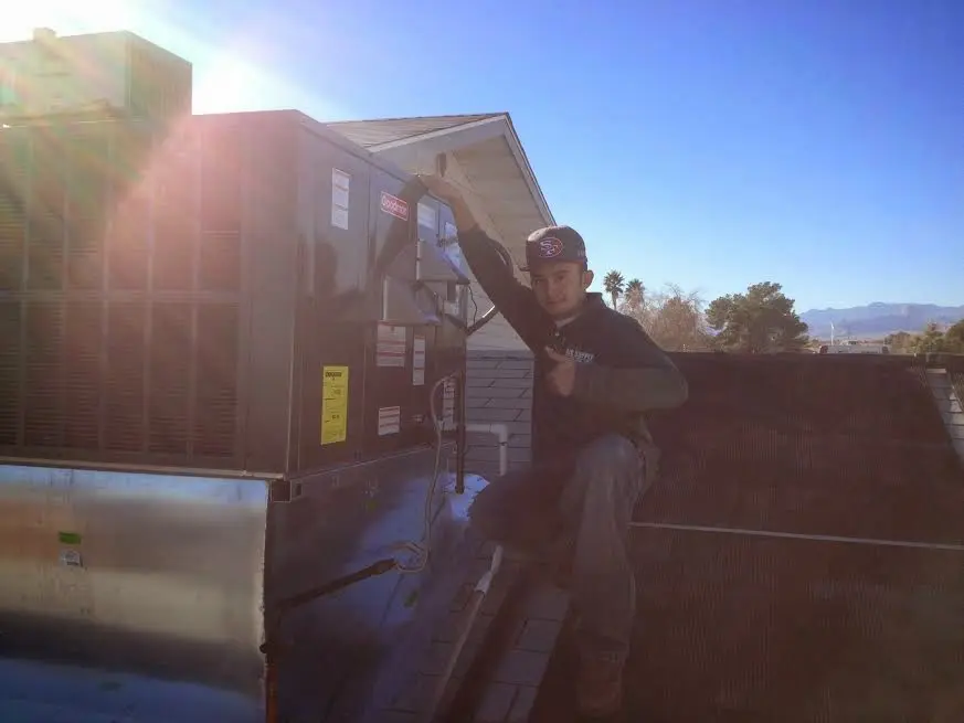 HVAC technician performing HVAC Inspection on a rooftop unit in Hollymead